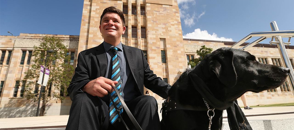 Fulbright Scholar Dr Paul Harpur, with his guide dog, Sean at the University of Queensland